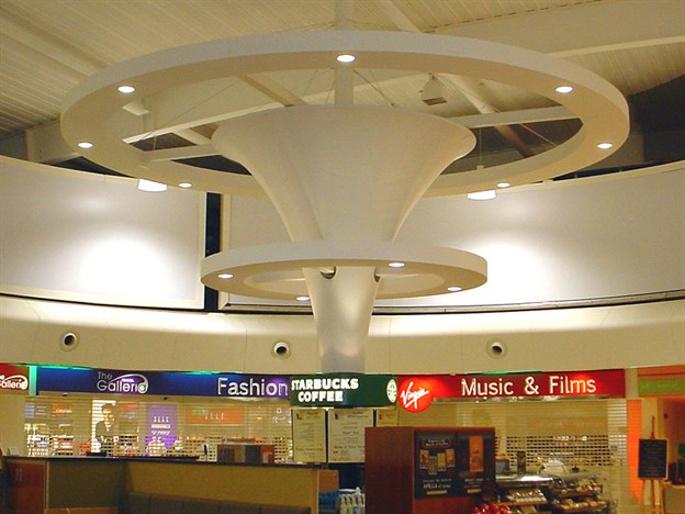 Suspended fabric-covered feature cones in a retail setting